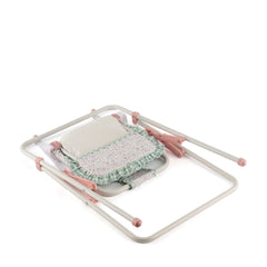 Folded pastel pink and white swing frame with floral-patterned fabric seat for dolls, designed for easy assembly.