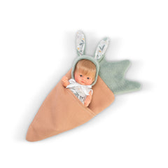 Small ASI Doll wrapped in carrot-themed blanket, wearing a bunny ear headband and floral outfit.