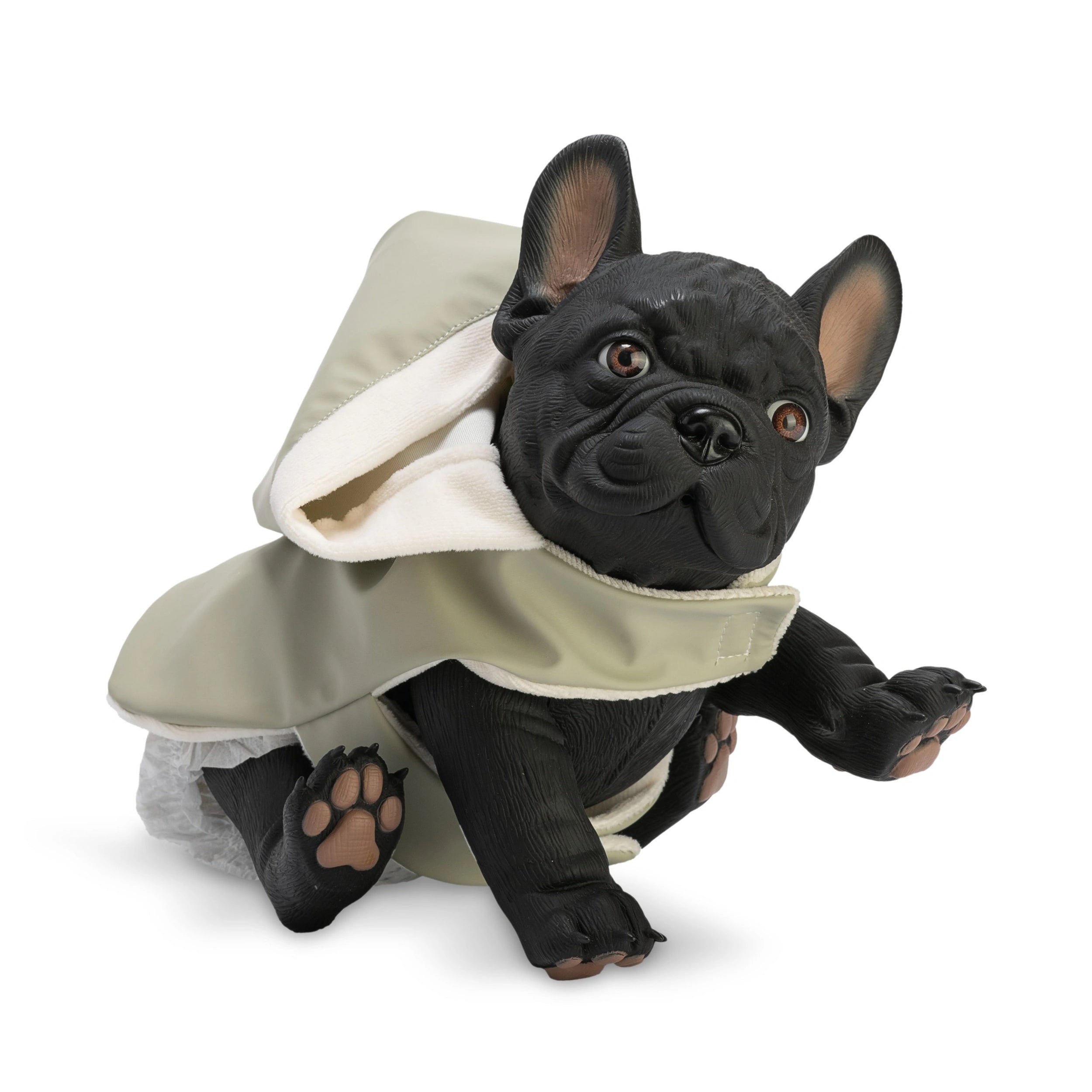 French Bulldog doll wearing a green raincoat, sitting with one paw raised.