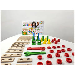 Colorful Alexander Constructor Junior set with wooden boards, red and yellow nuts, green and blue connectors, and wrenches on a white surface.