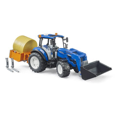 Blue New Holland T5.120 toy tractor with slip-on frontloader, orange hay trailer, and detachable forks on white background.