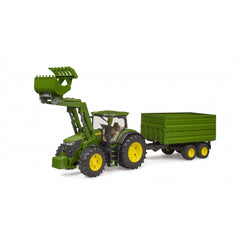 Green Bruder John Deere 7R 350 toy tractor with frontloader and tandem axle tipping trailer, on a white background.