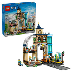 LEGO City Central Train Station (60469) set showcasing a detailed three-level structure with clock tower, coffee bar, and platforms for trains, featuring mini-figures engaging in various activities.