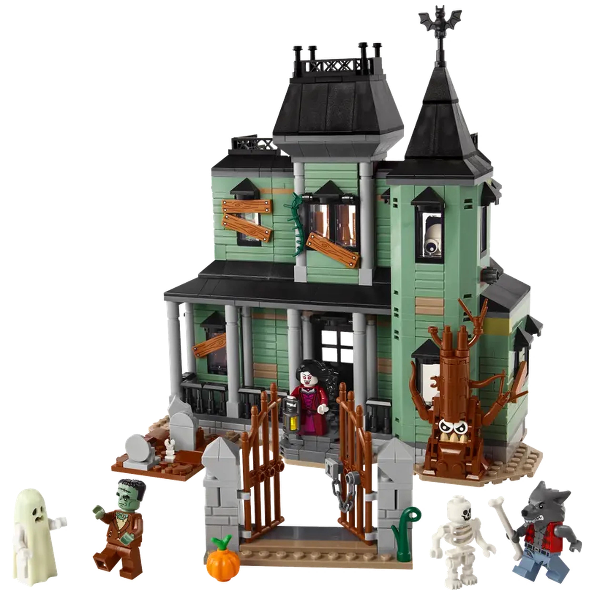 Haunted mansion constructed with green and gray bricks, featuring a detailed graveyard, spooky tree, and four character figures including a ghost, zombie, skeleton, and werewolf, along with an ornate front gate.