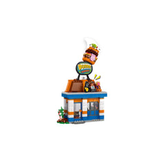 LEGO Fortnite Durrr Burger Restaurant set with colorful exterior, a burger sign on the roof, and mini-figures sitting outside.