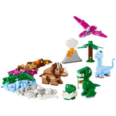 Colorful LEGO® dinosaur figures, including a T. rex, triceratops, and baby dinosaur, alongside a volcano and palm tree.