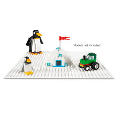 LEGO Classic White Baseplate featuring two penguin figures, a white igloo with a red flag, and a green tractor, all placed on a bright white base.
