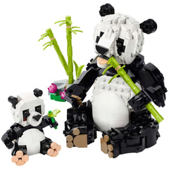 A detailed LEGO Panda Family set featuring a large adult panda and a smaller baby panda, both made of black and white bricks. The adult panda holds a bamboo stalk, while the baby panda plays with a small green piece. In the background, green bamboo shoots and a colorful flower arrangement enhance the scene, creating an engaging and vibrant playset designed for imaginative storytelling.