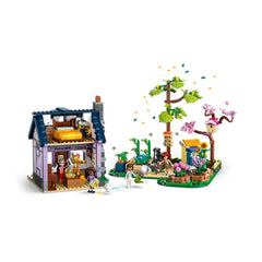 LEGO Friends Beekeepers' House and Flower Garden set featuring a two-story house, vibrant garden, and colorful characters, with a tree and animal figures.