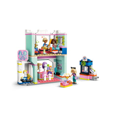LEGO Friends Hair Salon and Accessories Store features a colorful two-story salon with styling chairs, hair accessories, and three mini-dolls engaged in hairstyling play.
