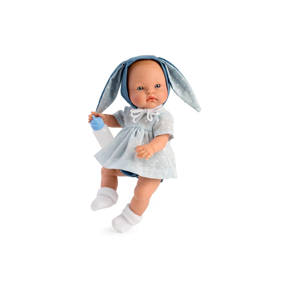ASI Dolls Alex Bunny Doll in a light blue polka dot dress with bunny ears, holding a baby bottle.