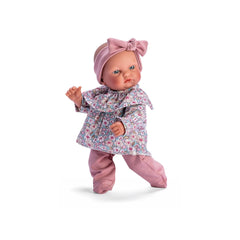 Gordi doll in a floral shirt and pink leggings, adorned with a matching pink headband, showcasing charming light-colored eyes.