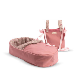 Pink doll carrycot and bag set with floral patterns and ribbon accents.