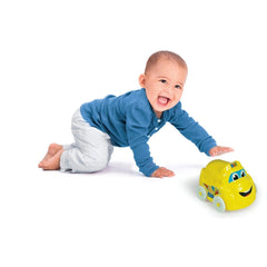 Baby Clementoni toy features a smiling face and wheels, as a toddler joyfully plays on a light-colored floor.
