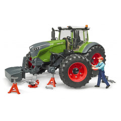 Toy tractor Fendt 1050 Vario with mechanic figure and tools, on jacks, showcasing realistic play and maintenance.