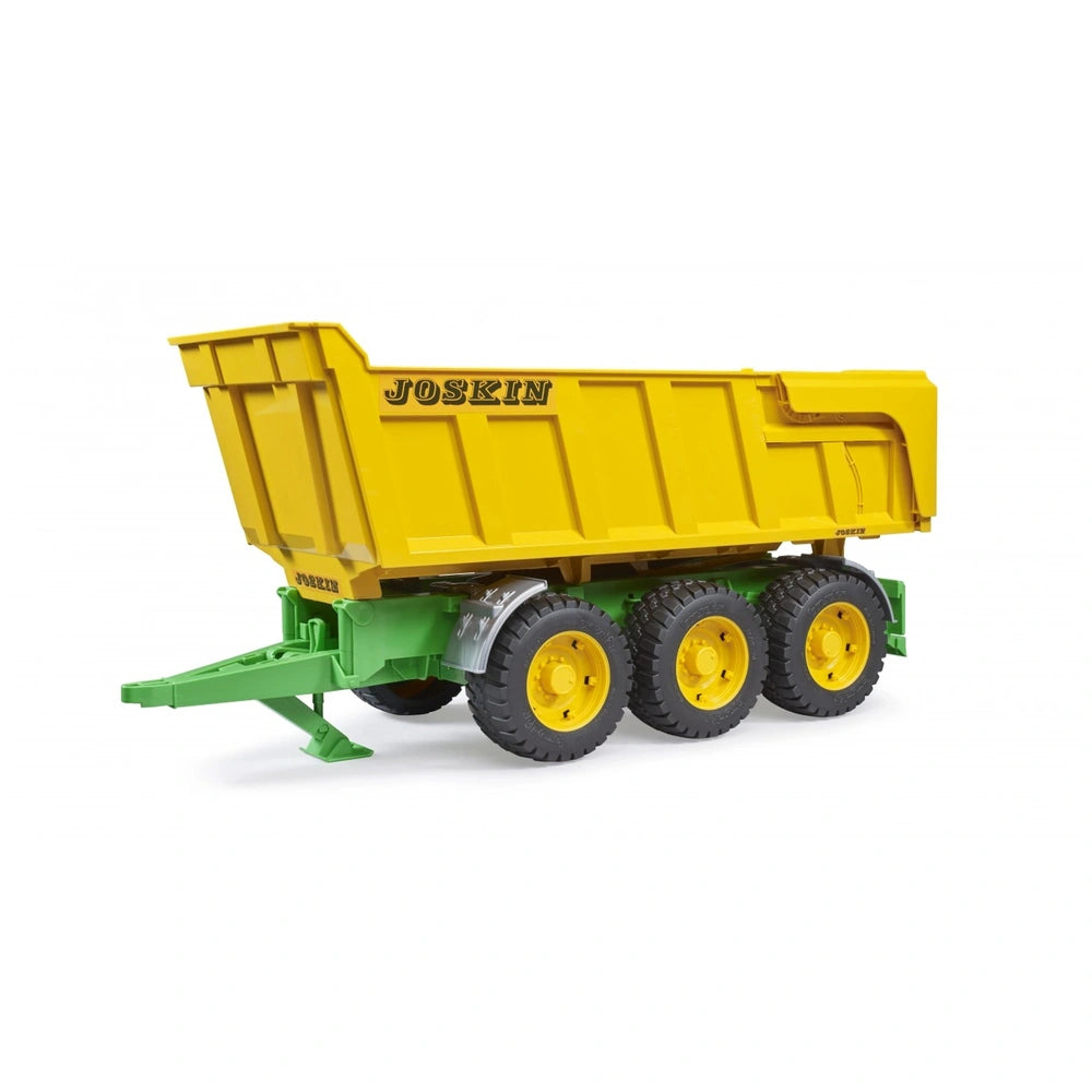 Yellow and green Bruder Joskin tipping trailer with three black wheels on a white background.