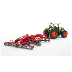Bruder Kuhn Discover XL Disc Harrow toy in red, attached to a green-black tractor on a white background.