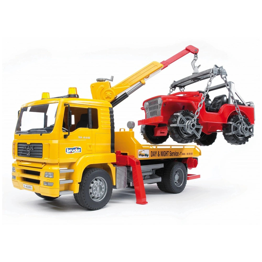 Yellow BRUDER MAN TGA breakdown truck with crane lifting red cross-country vehicle.