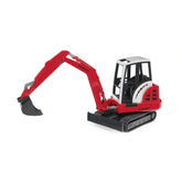 Red Bruder Schaeff HR16 Mini Excavator toy with operational arm and black tracks on white background.