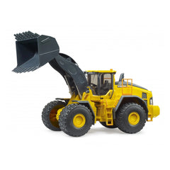 Yellow Volvo L260H wheel loader toy with black bucket raised, large textured tires, and detailed cab on white background.