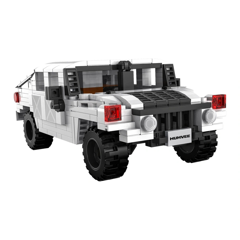 CaDA Humvee C-Series car construction set in white Lego bricks with black tires and red lights, viewed from the front.