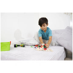 Eichhorn Constructor 3in1 Race Car set is being explored by a focused child sitting on a white bedspread surrounded by colorf