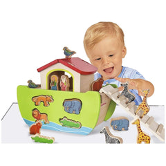 Eichhorn Noahs Ark toy playset featuring a toddler smiling and interacting with a colorful wooden boat and animal figures.