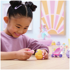 Hatchimals Alive Hatch N’ Stroll Playset with stroller toy and colorful mini figures is being enjoyed by a smiling girl at a