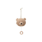Brown teddy bear hanging from a white string and hook, designed as a musical hanger for stuffed animals.