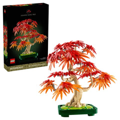 LEGO Botanicals Japanese Red Maple Bonsai Tree set with vibrant red and orange leaves, displayed on a green base with the box in the background.