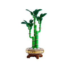 Three green bamboo stems rise gracefully from a round, brown pot adorned with pebbles, capturing the serene essence of nature.