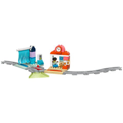 Colorful Lego Duplo Big Interactive Community Train set featuring a train station, tracks, and playful figures, encouraging imaginative play.