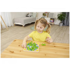 Noris My Frog Memory Game featuring a young girl in a yellow top playing in a bright, cheerful bedroom setting.