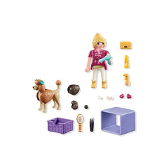 Playmobil Dog-Groomer toy playset features a blonde doll in pink and white, holding grooming tools and accessories.