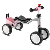 Puky Wutsch Bundle pink and gray quadricycle features black seat, handlebars, wheels with white centers, and pink basket.