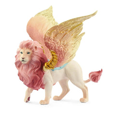 Winged lion figurine with pink and white fur, glossy yellow wings, and bright blue eyes, standing on a white surface.