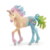 Marshmallow Unicorn Foal toy figure features a pink body, glittery mane and tail, and a metallic silver horn on a white surfa