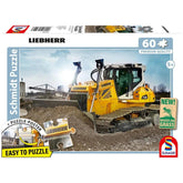Schmidt Spiele - Bulldozer PR736 puzzle packaging showcases a yellow Liebherr excavator at a construction site.