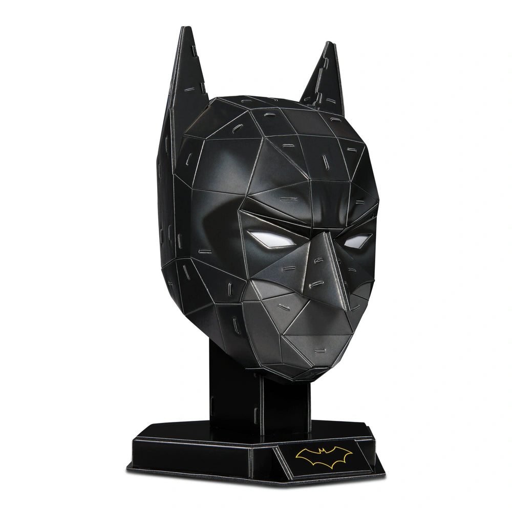 4D Build DC Batman mask puzzle model kit features a glossy black bat head with a yellow symbol, standing upright on a base.