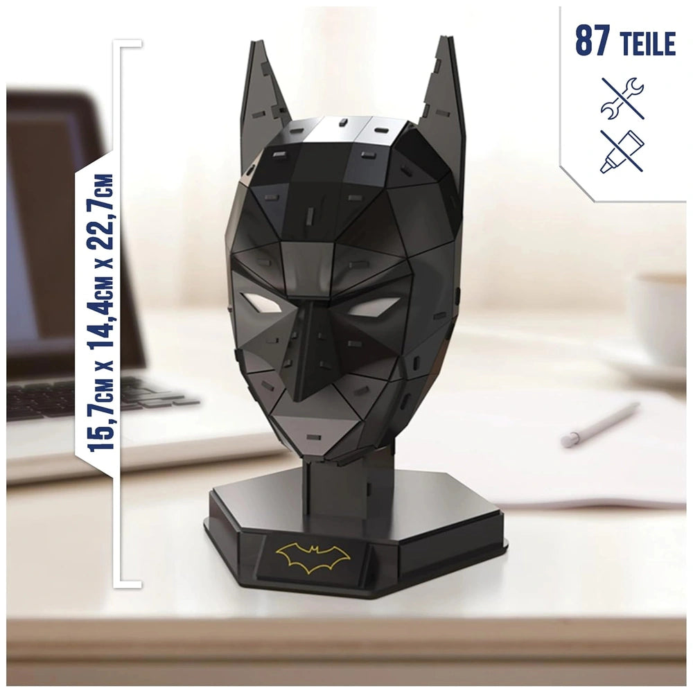 4D Build DC Batman Mask 3D puzzle model kit in black with yellow logo, featuring a geometric design on a smooth surface.