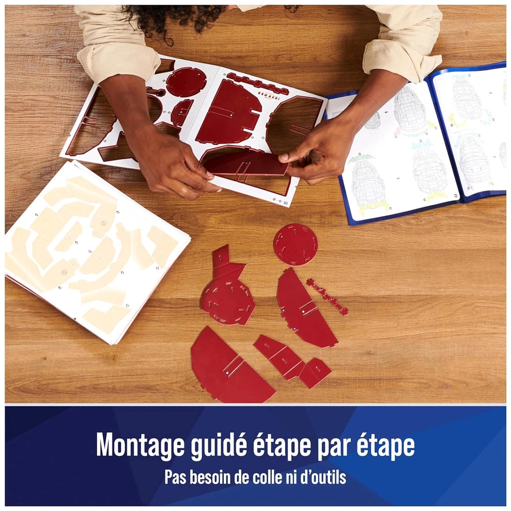 4D Build Marvel Iron Man 3D Puzzle Model Kit is being assembled on a wooden table with various craft materials.