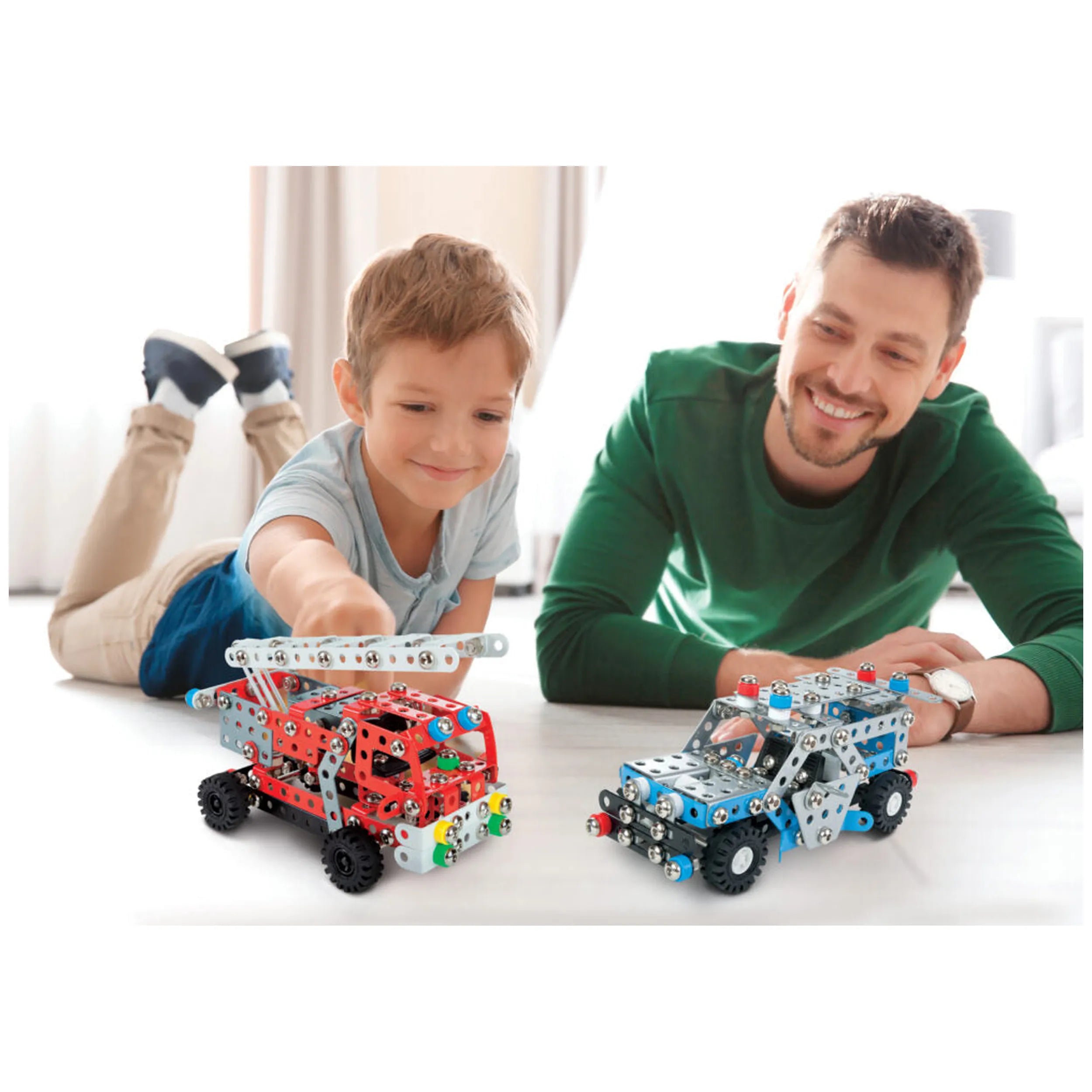 Child and adult enjoying Alexander Constructor Police Car sets, featuring colorful metal vehicle models on a table.