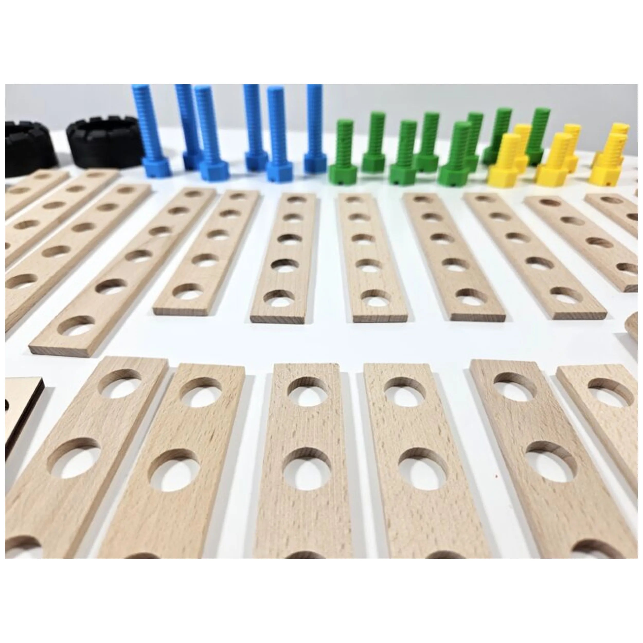 Wooden boards with holes, blue, green, yellow screws from Alexander Constructor Junior 100-piece set on white background.