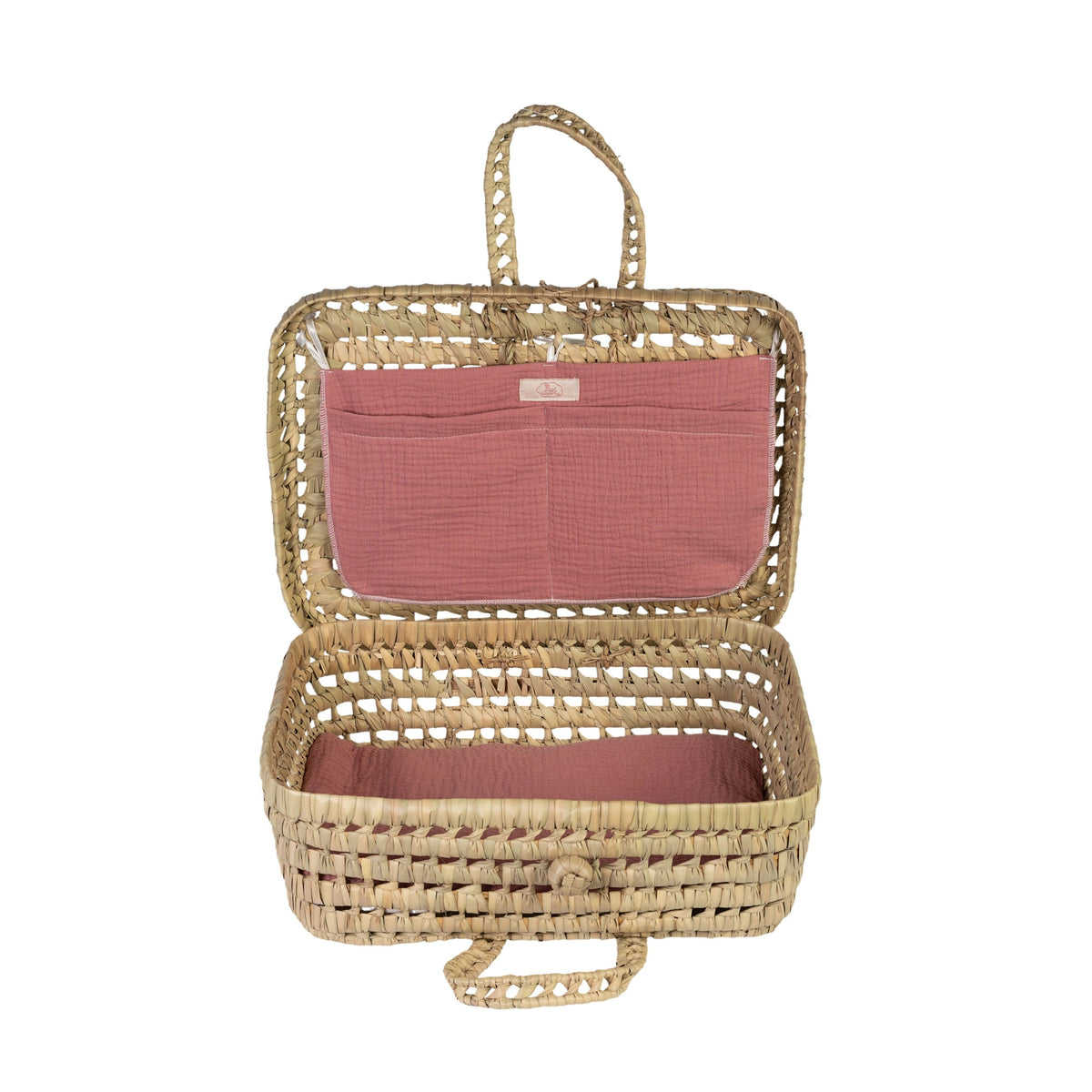 Open palm leaf suitcase with pink muslin lining and woven handles, designed for dolls and accessories.