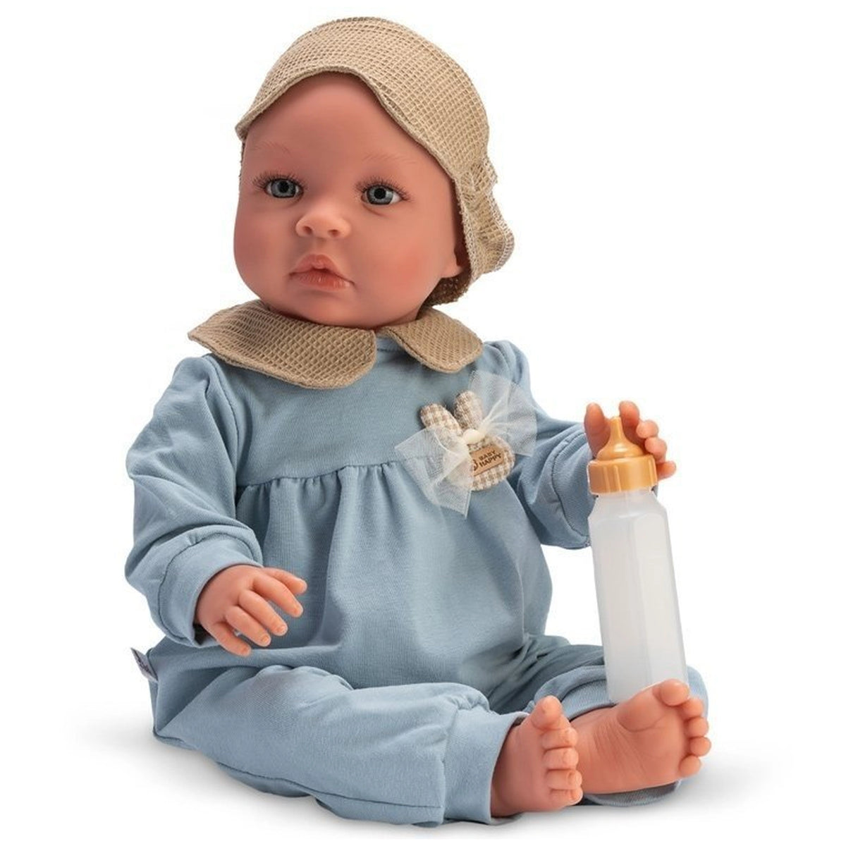 Charming 46 cm Leo doll in blue pajamas, wearing a beige hat and holding a bottle, seated with a gentle expression.