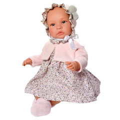 ASI Dolls Leo 46 cm in a floral dress and pink jacket, with a matching bonnet and slippers.
