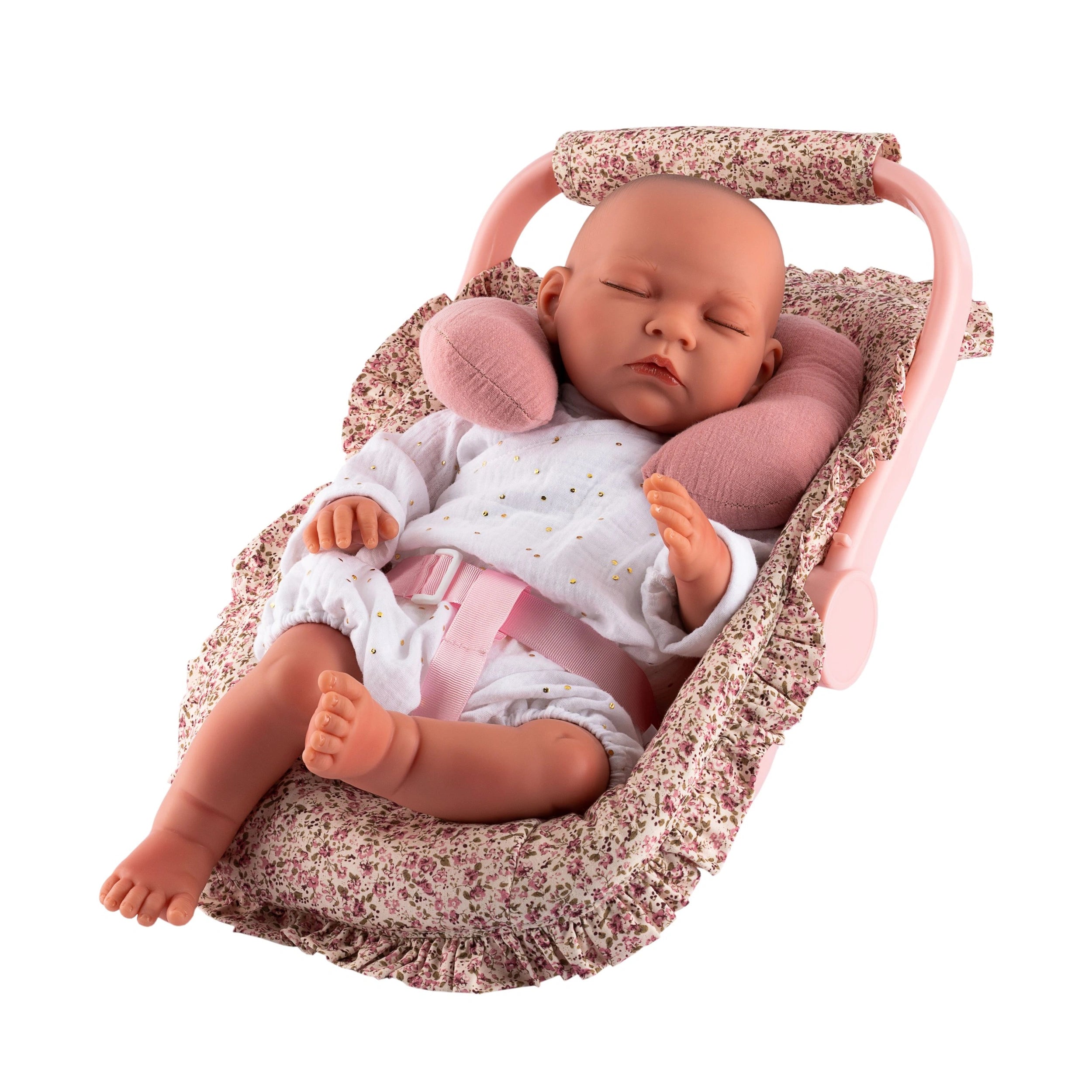 Doll in floral fabric pram with pink neck cushion, wearing white onesie, seated in Maxi-Cosi from Asi Dolls' Martina Collection.