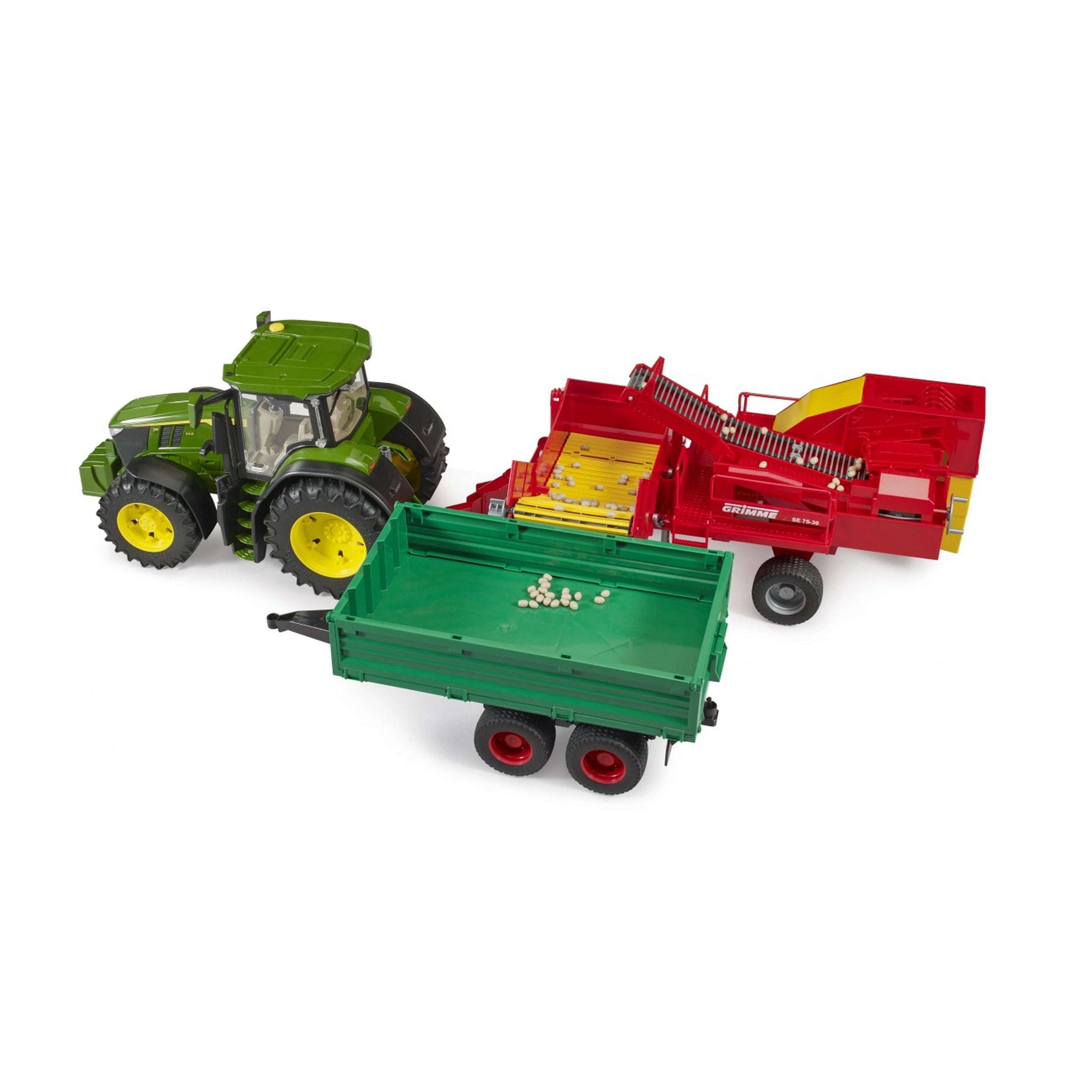 Green tractor towing a red Grimme SE75-30 potato digger with green trailer loaded with imitation potatoes.