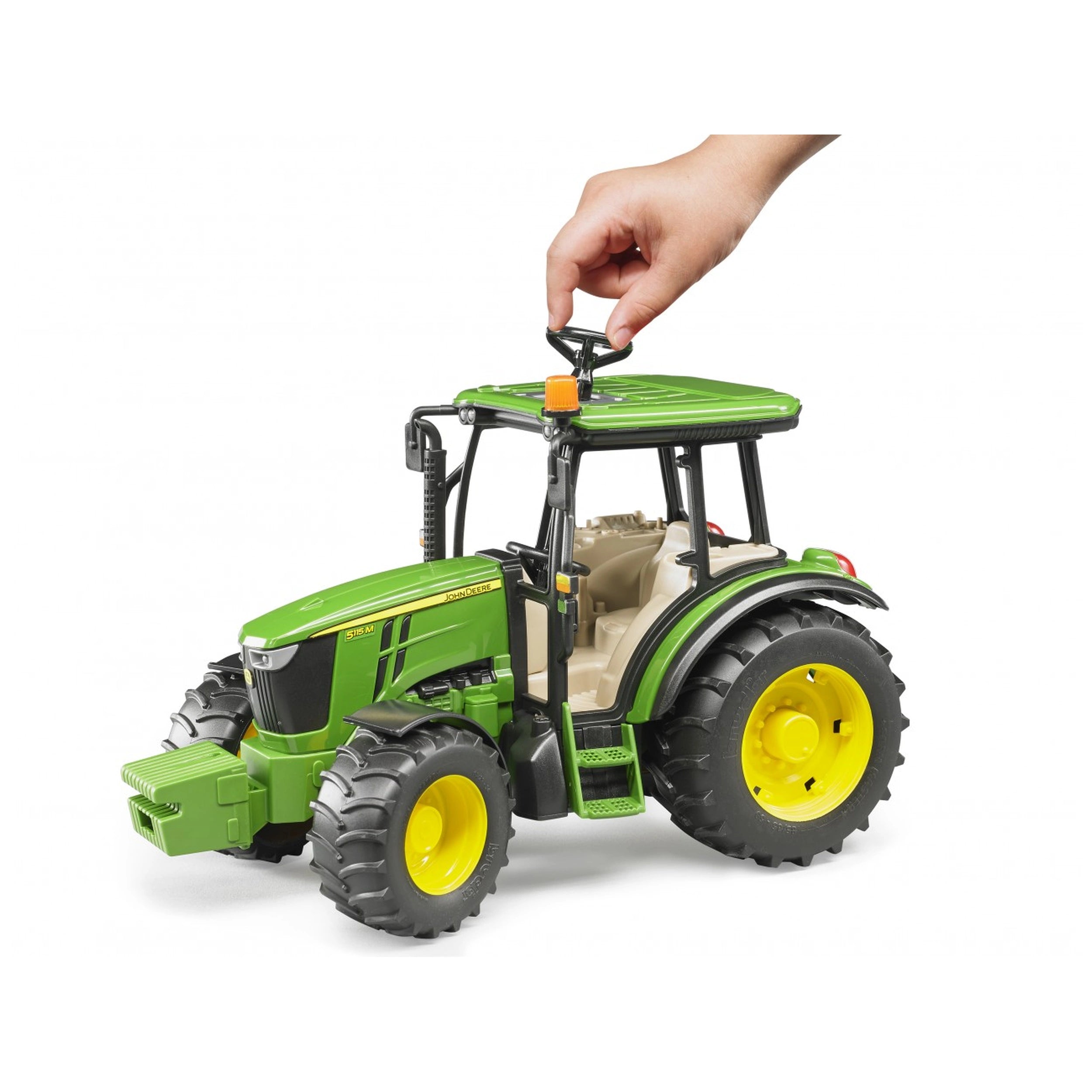 Green BRUDER John Deere 5115 M toy tractor, realistic details, hand steering extension on roof, large yellow wheels.