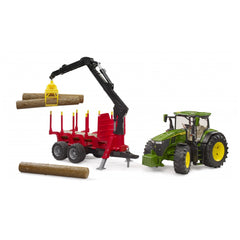 Green John Deere 7R 350 tractor with red forestry trailer, crane lifting logs.